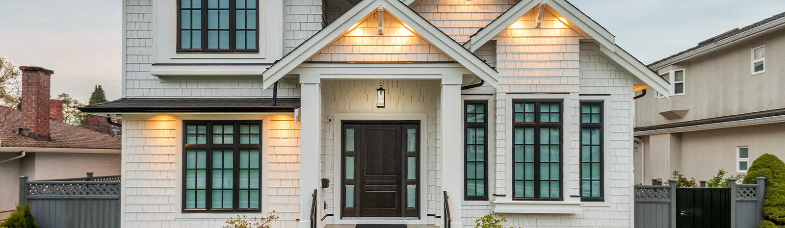 White paneled two-story house in a neighborhood